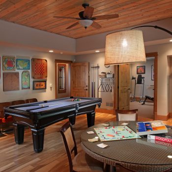 The terrace level (basement) game room is perfect for keeping family and friends entertained. Just beyond the game room is a well outfitted exercise room.